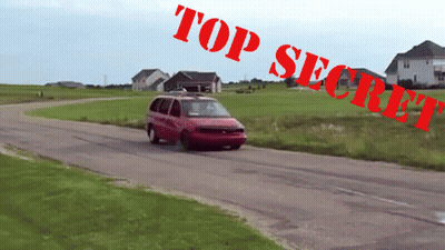 A Red Van Is Driving Down A Road With Top Secret Written On The Bottom GIF