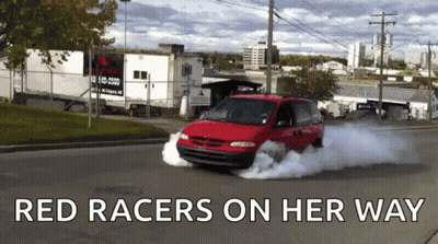 A Red Van Is Driving Down A Street With The Words Red Racers On Her Way GIF