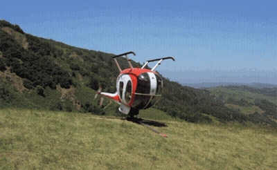 A Red White And Black Helicopter With The Number 10 On The Side GIF