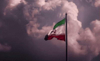 A Red White And Green Flag Is Flying In The Wind GIF