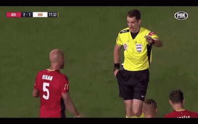 A Referee Gives A Yellow Card To A Player With The Number 5 GIF