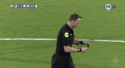 A Referee Holds Up A Yellow Card During A Soccer Match GIF