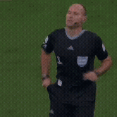 A Referee Holds Up A Yellow Card That Says Fifa GIF