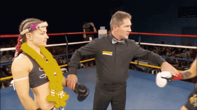 A Referee In A Boxing Ring With The Word Apparel On His Sweatshirt GIF