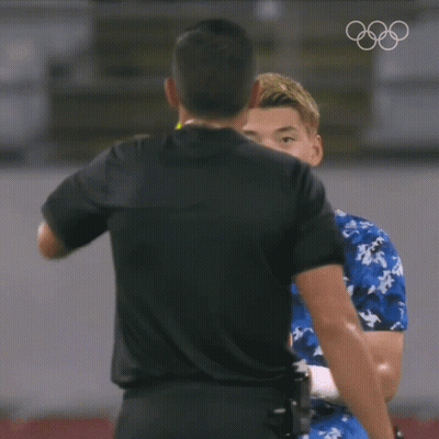 A Referee Is Giving A Yellow Card To A Player In A Blue Shirt GIF