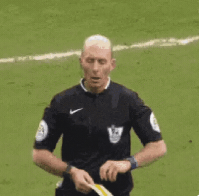 A Referee Is Giving A Yellow Card To A Soccer Player On A Field . GIF