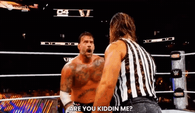 A Referee Is Standing Next To A Wrestler In A Wrestling Ring And Asking Him If He Is Kidding Him . GIF