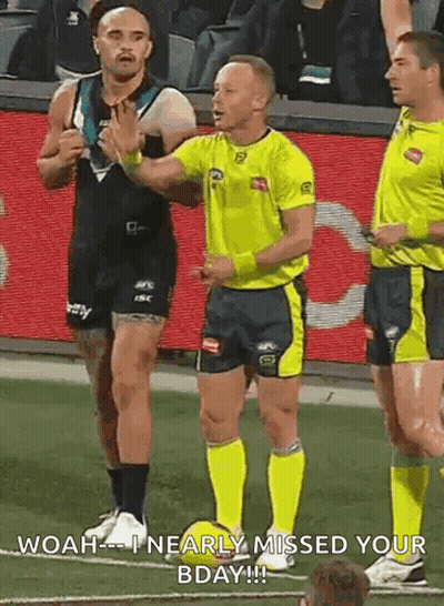 A Referee Is Talking To A Player On A Soccer Field While Another Player Looks On . GIF