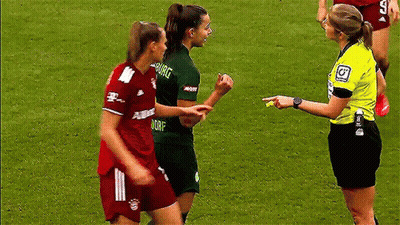 A Referee Is Talking To Two Female Soccer Players One Of Whom Is Wearing A Shirt That Says Dorf GIF