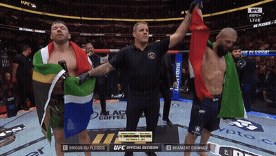A Referee Stands Between Two Fighters During A Ufc Fight GIF