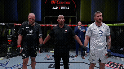 A Referee Stands Between Two Fighters In A Ufc Fight GIF