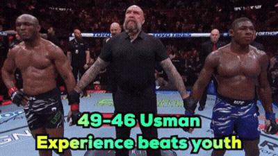 A Referee Stands Between Two Fighters With The Words 49-46 Usman Experience Beats Youth Below Him GIF