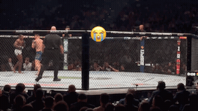 A Referee Stands In A Boxing Ring With A Tear Coming Out Of His Eyes GIF
