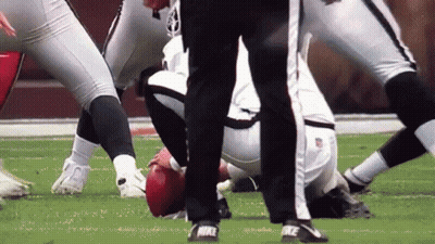 A Referee Stands Near A Football Player Wearing Nike Cleats GIF