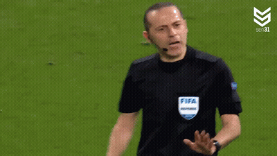 A Referee Wearing A Fifa Referee Shirt Is Talking To A Player GIF