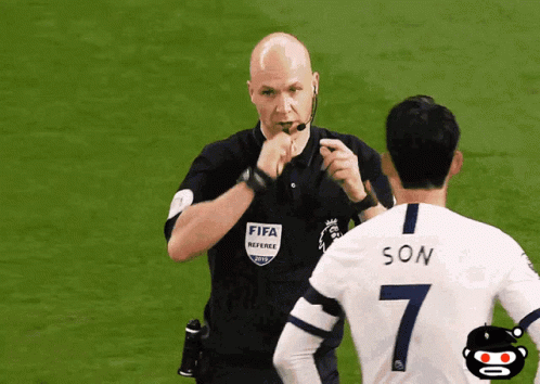 A Referee Wearing A Fifa Referee Shirt Talks To A Soccer Player Wearing A Number 7 GIF
