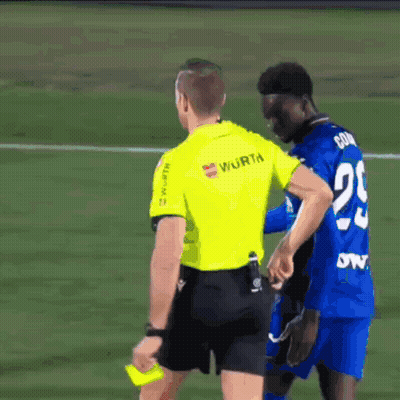 A Referee Wearing A Yellow Shirt That Says Wurth GIF