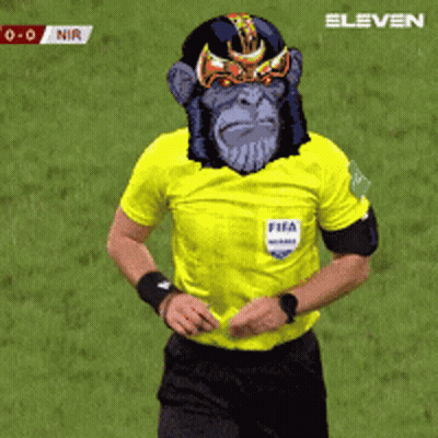 A Referee Wearing A Yellow Shirt With A Monkey Face On His Face GIF