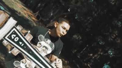 A Reflection Of A Person In A Puddle Of Water With Trees In The Background GIF