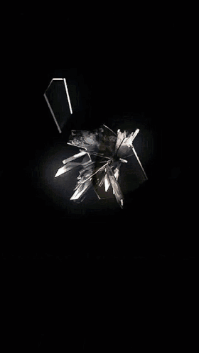 A Reflection Of A Person 'S Face In A Broken Glass GIF