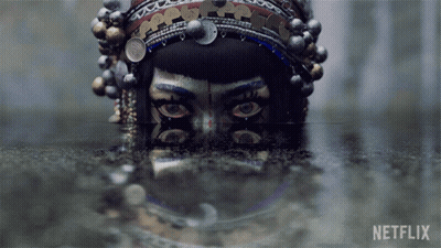 A Reflection Of A Woman 'S Face In A Body Of Water With Netflix Written On The Bottom GIF