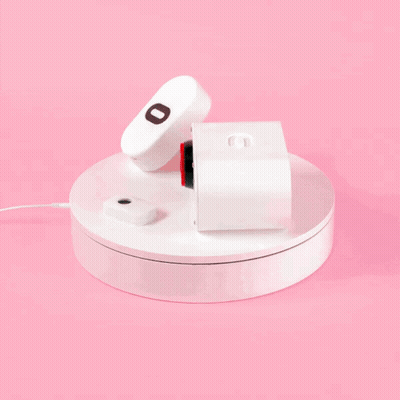 A Remote Control With The Letter O On It Sits On A White Circle GIF
