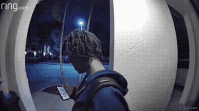 A Ring.com Video Of A Person Looking At Their Phone GIF