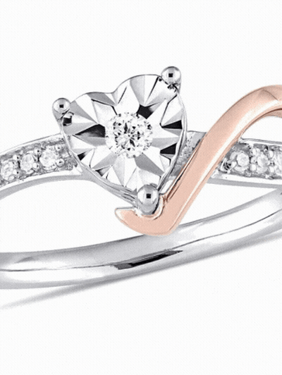 A Ring With A Heart Shaped Diamond In The Middle GIF