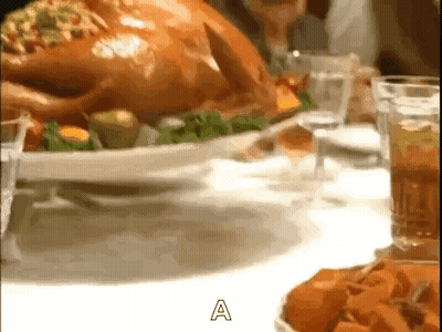 A Roasted Turkey Is Sitting On A White Plate On A Table Next To A Glass Of Wine . GIF