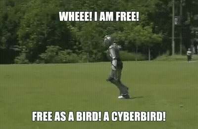 A Robot Is Running In A Field With The Words `` Free As A Bird ! A Cyberbird ! '' Written On It . GIF