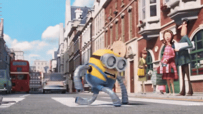 A Robot Minion Is Walking Down A Street GIF