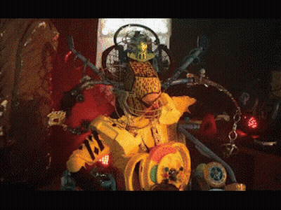 A Robot With A Yellow Shirt That Says ' Tiger ' On It 'S Chest GIF