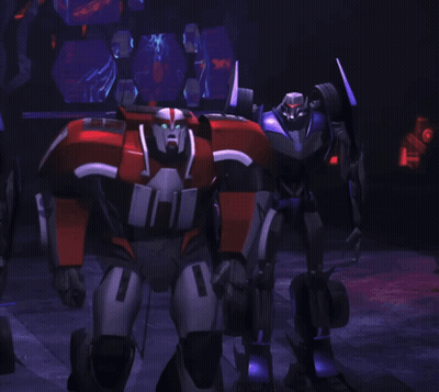 A Robot With The Number 1 On It Stands In A Dark Room GIF