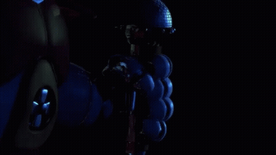 A Robotic Hand Is Giving A Thumbs Up In The Dark . GIF