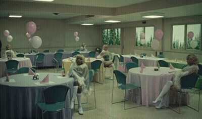 A Room Filled With Tables And Chairs With Balloons On Them GIF