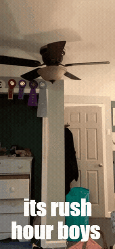 A Room With A Ceiling Fan And The Words " It 'S Rush Hour Boys " On The Bottom GIF