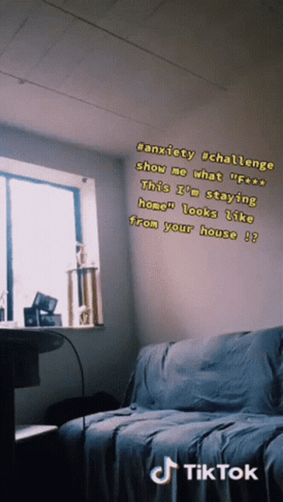 A Room With A Couch And A Window With A Tik Tok Sticker On The Wall GIF