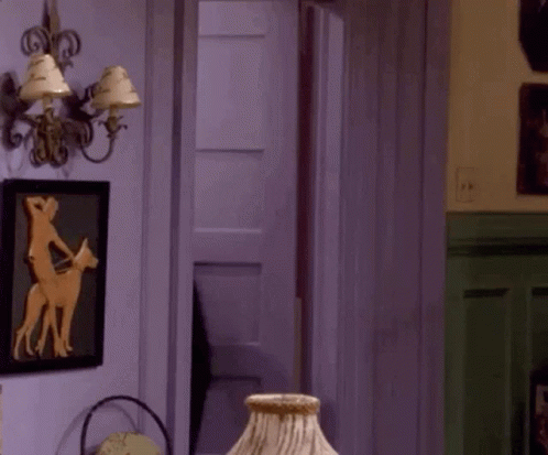 A Room With A Lamp And A Picture Of A Man Riding A Horse GIF