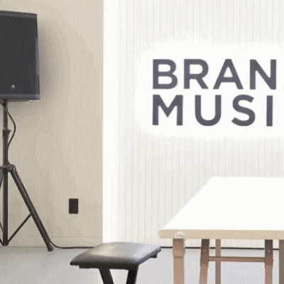 A Room With A Sign That Says Bran Music On It GIF