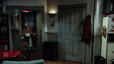 A Room With A Sink And A Refrigerator With A Picture Of Superman On It GIF