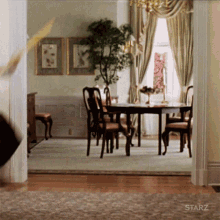 A Room With A Starz Logo On The Wall GIF