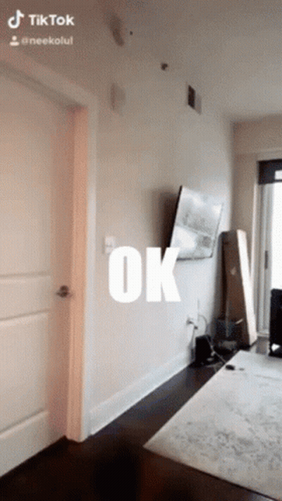 A Room With A Tv On The Wall And The Word Ok Written On It GIF