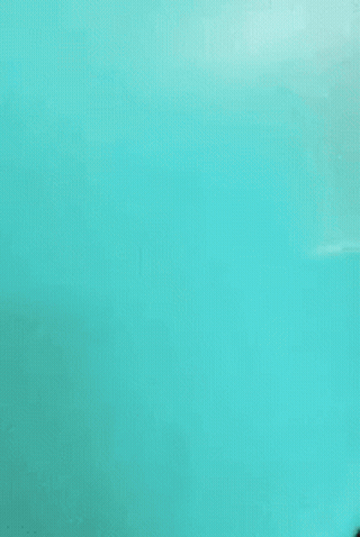 A Room With Teal Walls And A Bed In It GIF