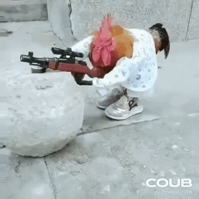 A Rooster Is Holding A Gun Next To A Snowball On The Sidewalk . GIF