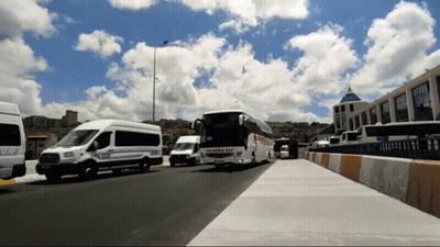 A Row Of Buses Are Parked On The Side Of A Road And One Of Them Has The Word Palmur On The Side GIF
