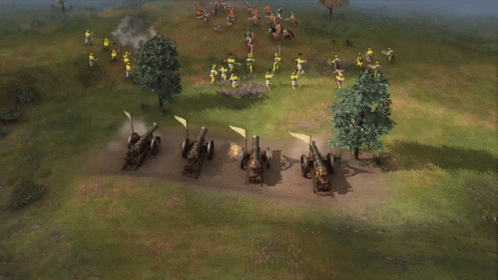 A Row Of Cannons Are Lined Up In A Field And Shooting GIF