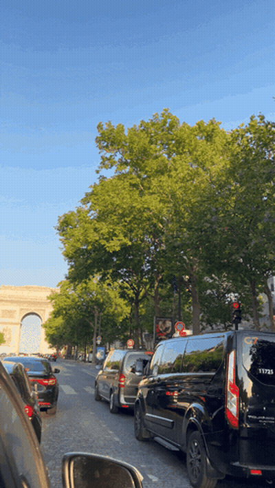 A Row Of Cars Are Lined Up On A Busy Street GIF