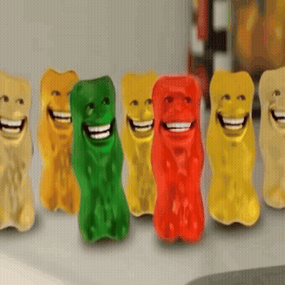 A Row Of Colorful Gummy Bears With Smiley Faces On Them GIF