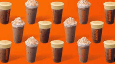 A Row Of Dunkin 'S Coffee Cups On An Orange Background GIF