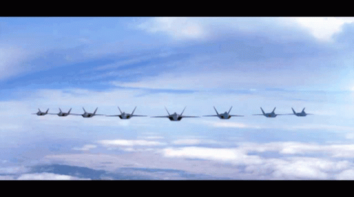 A Row Of Fighter Jets Flying In A Row In The Sky GIF